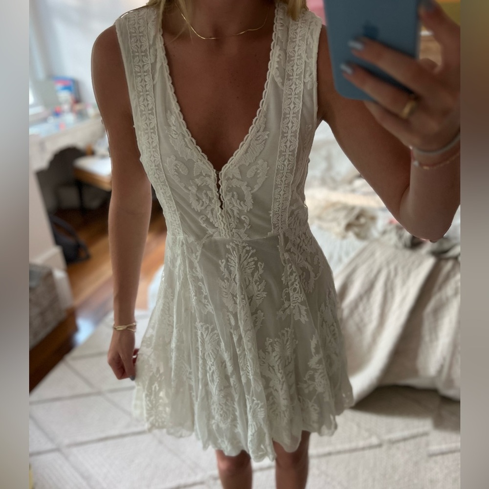 Chic white lace dress with a sheer back
